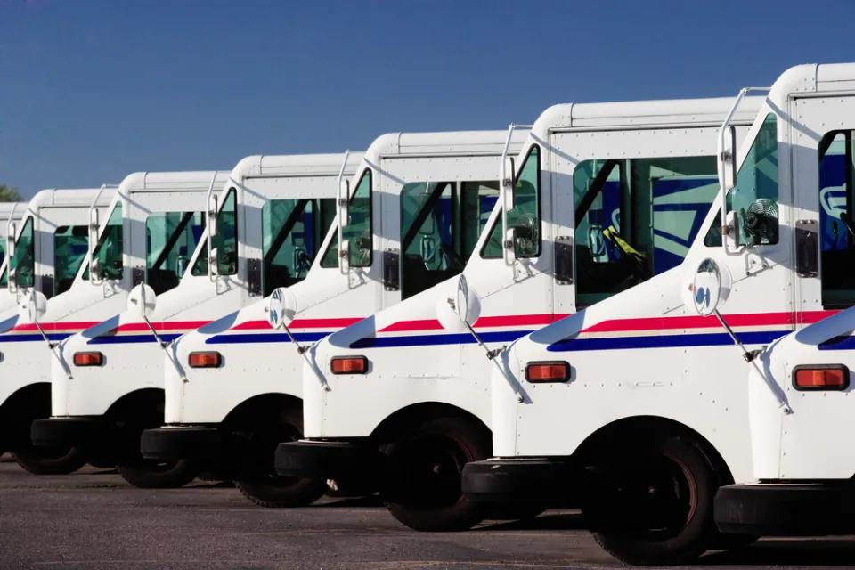 A row of USPS delivery trucks